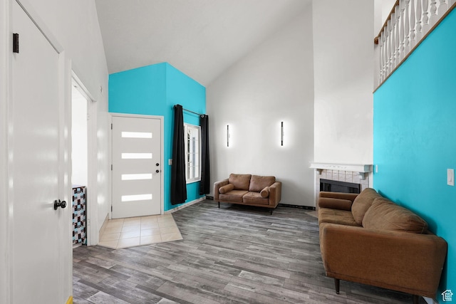 1428 W Beacon Hill Cir S Unit 1428, Salt Lake City, UT 84123 - entrance foyer featuring high vaulted ceiling, wood finished floors, and a tile fireplace