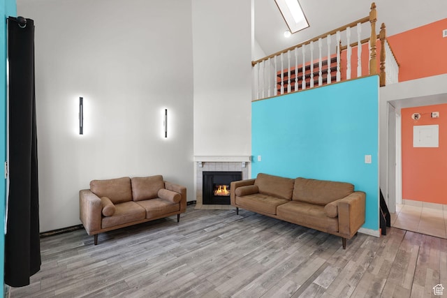 1428 W Beacon Hill Cir S Unit 1428, Salt Lake City, UT 84123 - living area featuring a towering ceiling, wood finished floors, and a tiled fireplace
