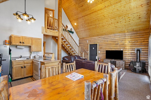 5 Mirror Lake Hwy Unit 5-2, Coalville, UT 84017 - dining room featuring high vaulted ceiling, rustic walls, a wood stove, stairs, and dark carpet