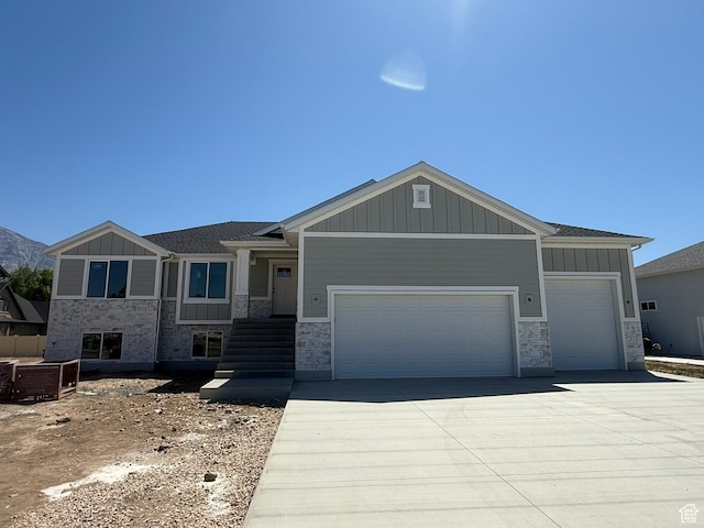 3274 N 2500 W, Farr West, UT 84404 - view of front of property featuring an attached garage, board and batten siding, stone siding, and driveway