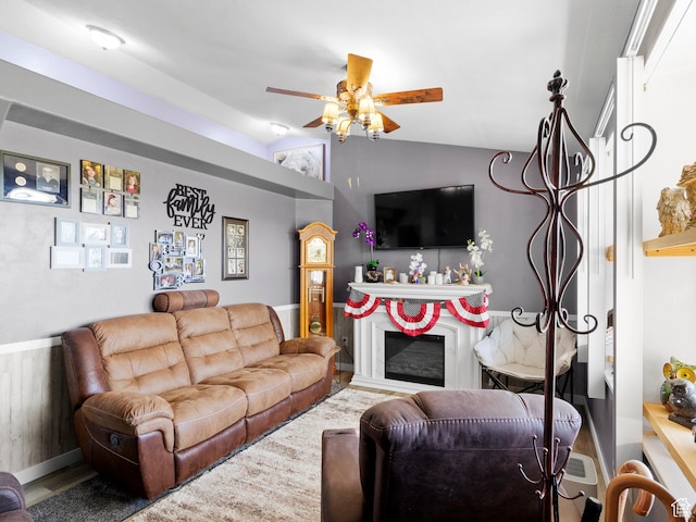 3646 S Elk Point Dr, Magna, UT 84044 - living room with vaulted ceiling, a ceiling fan, and a glass covered fireplace