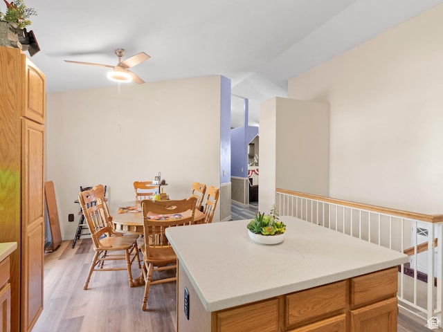 3646 S Elk Point Dr, Magna, UT 84044 - kitchen with ceiling fan, light wood-type flooring, light countertops, and a kitchen island