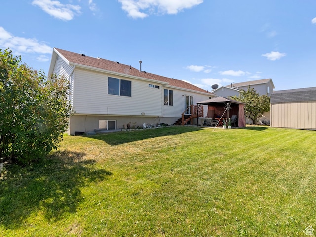 3646 S Elk Point Dr, Magna, UT 84044 - rear view of property featuring a gazebo, a lawn, and a storage shed