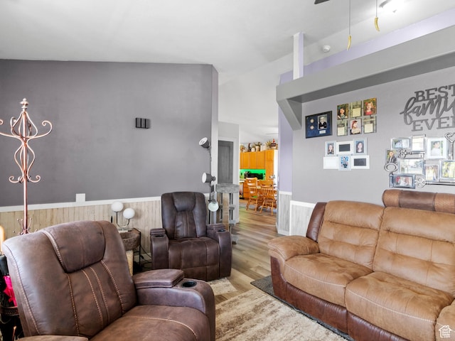 3646 S Elk Point Dr, Magna, UT 84044 - living area with wood finished floors, wainscoting, ceiling fan, and wooden walls