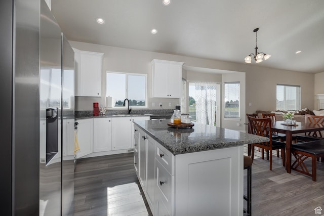 933 S 250 W, Vernal, UT 84078 - kitchen with stainless steel fridge with ice dispenser, dark wood-style flooring, a center island, white cabinetry, and recessed lighting