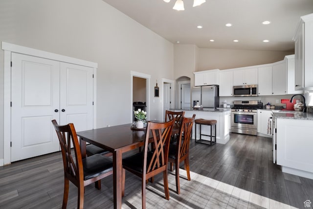 933 S 250 W, Vernal, UT 84078 - dining area featuring high vaulted ceiling, arched walkways, dark wood-style floors, and recessed lighting