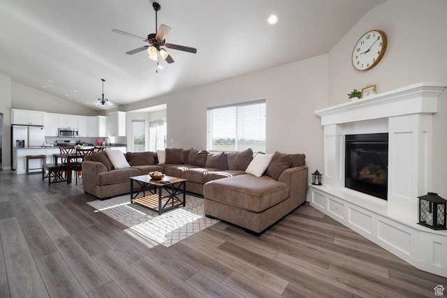 933 S 250 W, Vernal, UT 84078 - living area with vaulted ceiling, ceiling fan, dark wood-style flooring, a glass covered fireplace, and recessed lighting