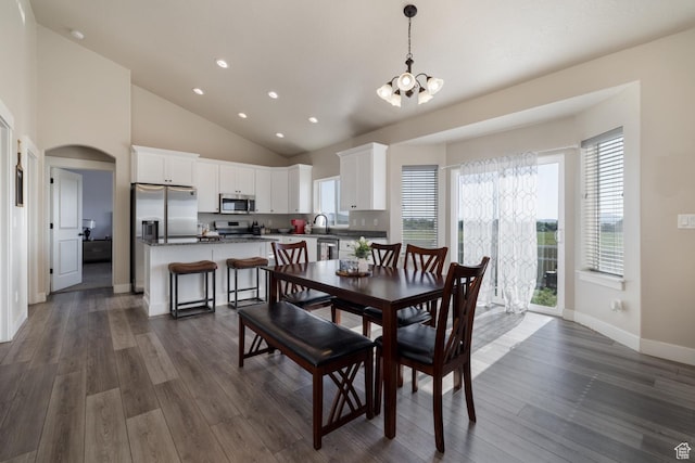 933 S 250 W, Vernal, UT 84078 - dining area featuring a chandelier, dark wood finished floors, recessed lighting, arched walkways, and high vaulted ceiling
