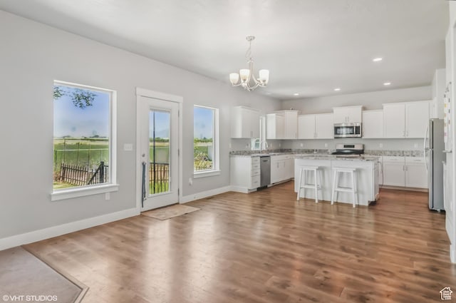 2086 W White Pine Dr S, Layton, UT 84041 - kitchen with appliances with stainless steel finishes, a chandelier, white cabinetry, a kitchen island, and recessed lighting