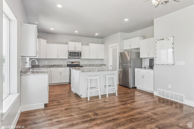 2086 W White Pine Dr S, Layton, UT 84041 - kitchen featuring stainless steel appliances, a center island, white cabinetry, recessed lighting, and dark wood-style flooring