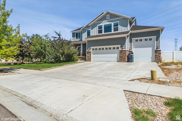 2086 W White Pine Dr S, Layton, UT 84041 - view of front facade with board and batten siding, stone siding, driveway, and an attached garage