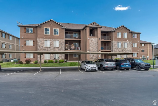 3569 E Rock Creek Rd Unit G1, Eagle Mountain, UT 84005 - view of apartment building / complex featuring covered parking