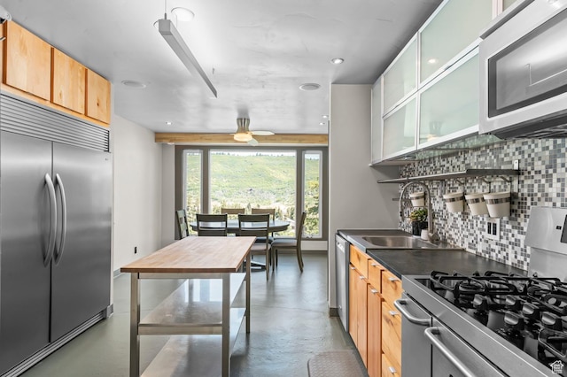 105 S Crestview Cir, Park City, UT 84098 - kitchen with appliances with stainless steel finishes, concrete flooring, tasteful backsplash, ceiling fan, and dark countertops