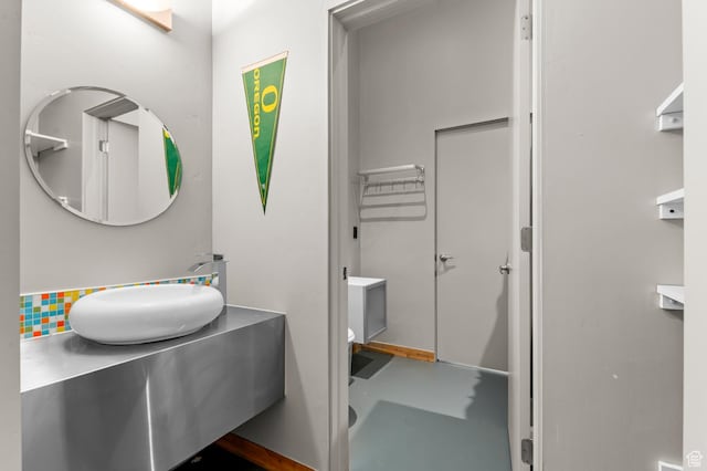105 S Crestview Cir, Park City, UT 84098 - bathroom featuring concrete flooring, vanity, and decorative backsplash