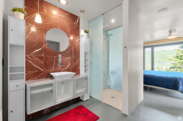 105 S Crestview Cir, Park City, UT 84098 - ensuite bathroom with finished concrete flooring, walk in shower, vanity, tile walls, and recessed lighting