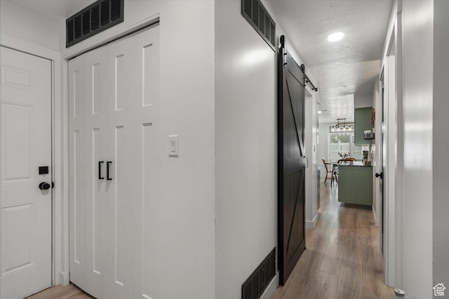 866 Brookside Ln, Centerville, UT 84014 - corridor featuring a barn door and light wood-type flooring