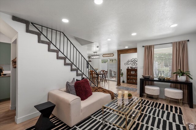 866 Brookside Ln, Centerville, UT 84014 - living room featuring wood finished floors, recessed lighting, a textured ceiling, and stairway