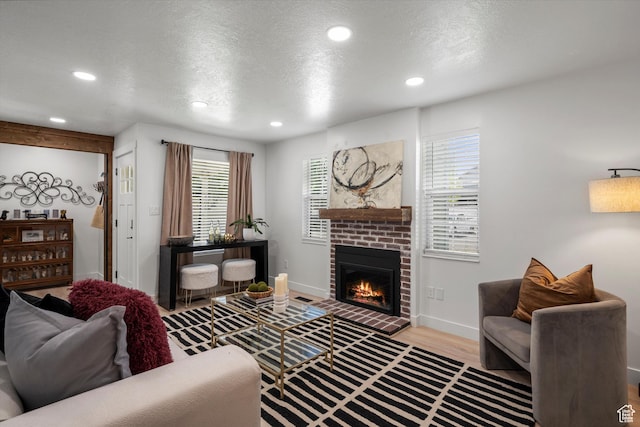 866 Brookside Ln, Centerville, UT 84014 - living area with a brick fireplace, recessed lighting, a textured ceiling, and wood finished floors