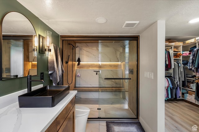 866 Brookside Ln, Centerville, UT 84014 - full bathroom featuring vanity, a walk in closet, a marble finish shower, and a textured ceiling