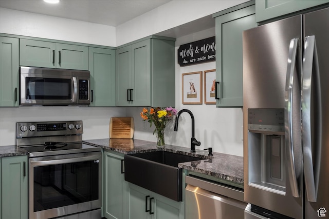 866 Brookside Ln, Centerville, UT 84014 - kitchen with appliances with stainless steel finishes, green cabinetry, and dark stone counters