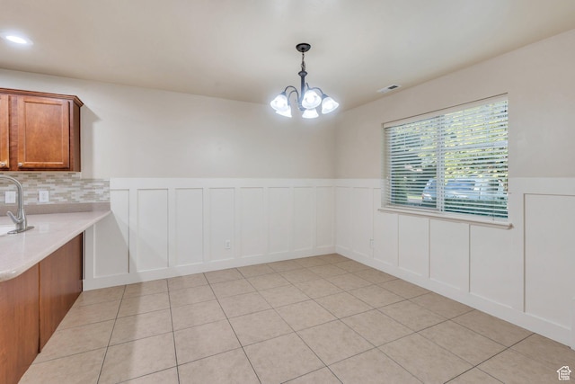 1158 W 150 S, Springville, UT 84663 - unfurnished dining area featuring a chandelier, light tile patterned floors, a wainscoted wall, a decorative wall, and recessed lighting