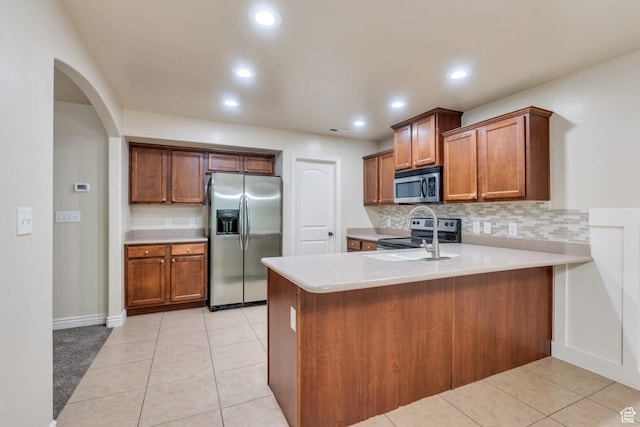 1158 W 150 S, Springville, UT 84663 - kitchen featuring stainless steel appliances, a peninsula, arched walkways, light countertops, and decorative backsplash