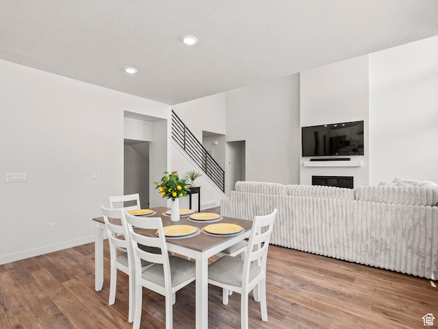 1583 W Andover Rd, South Jordan, UT 84095 - dining area with light wood-style floors, a glass covered fireplace, and recessed lighting