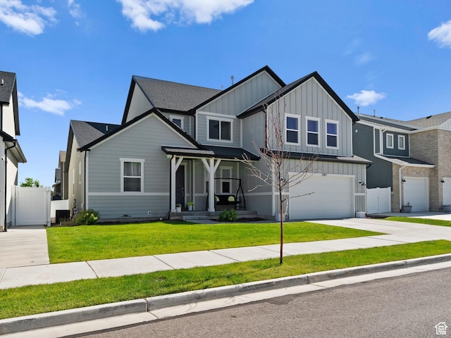 1583 W Andover Rd, South Jordan, UT 84095 - view of front of property featuring board and batten siding, driveway, an attached garage, a gate, and a shingled roof