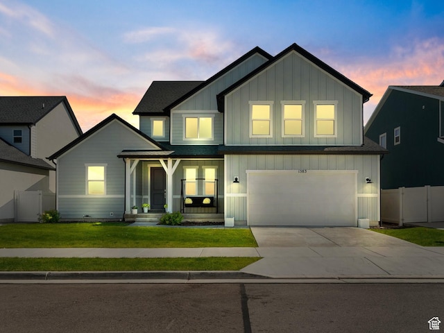 1583 W Andover Rd, South Jordan, UT 84095 - view of front of house with board and batten siding, an attached garage, driveway, and roof with shingles