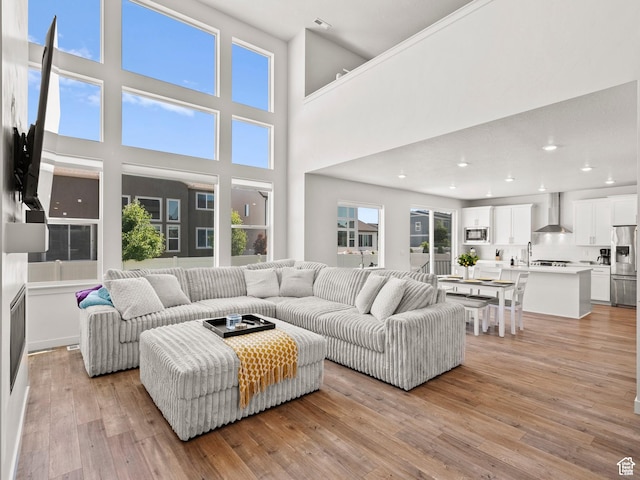 1583 W Andover Rd, South Jordan, UT 84095 - living area with light wood finished floors, recessed lighting, and a high ceiling