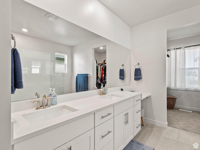 1583 W Andover Rd, South Jordan, UT 84095 - bathroom featuring double vanity, a spacious closet, and a walk in shower