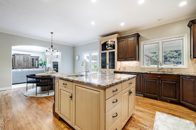 999 S Fairway Cir, Fruit Heights, UT 84037 - kitchen with light stone countertops, tasteful backsplash, light wood-style flooring, dark brown cabinetry, and recessed lighting