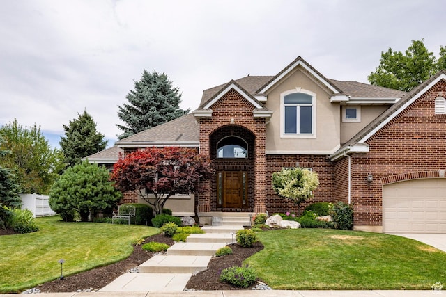 999 S Fairway Cir, Fruit Heights, UT 84037 - traditional-style house featuring stucco siding, a front lawn, a garage, and brick siding