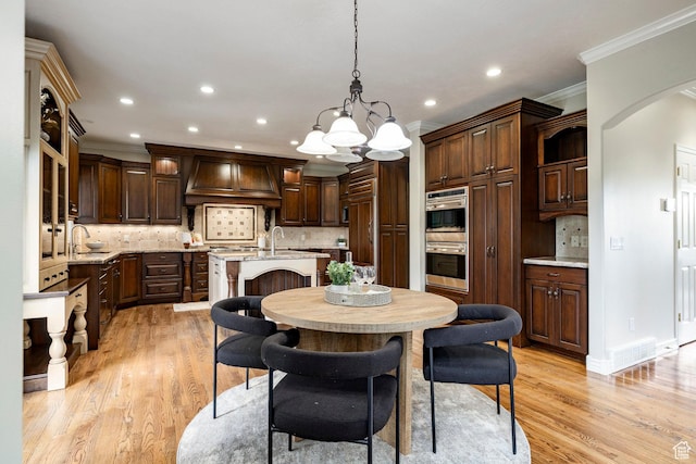 999 S Fairway Cir, Fruit Heights, UT 84037 - dining area featuring crown molding, light wood finished floors, a chandelier, recessed lighting, and arched walkways