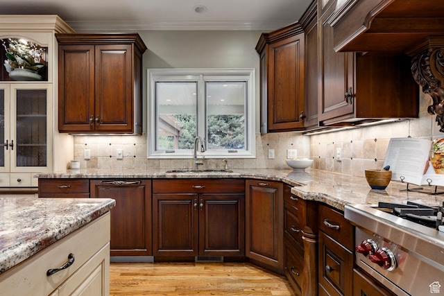 999 S Fairway Cir, Fruit Heights, UT 84037 - kitchen with light stone countertops, light wood-style flooring, backsplash, ornamental molding, and stainless steel gas cooktop