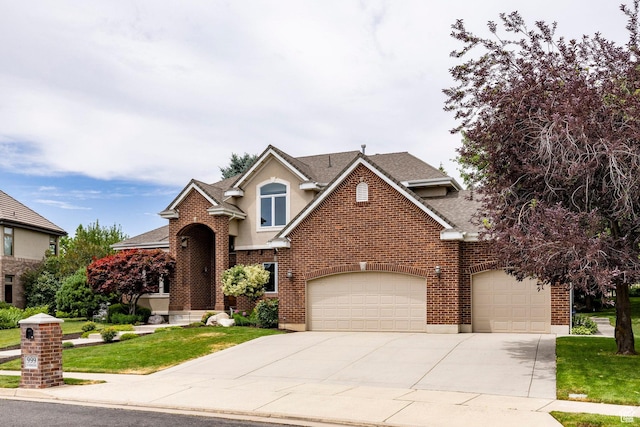 999 S Fairway Cir, Fruit Heights, UT 84037 - traditional-style house with driveway, an attached garage, a shingled roof, a front yard, and brick siding