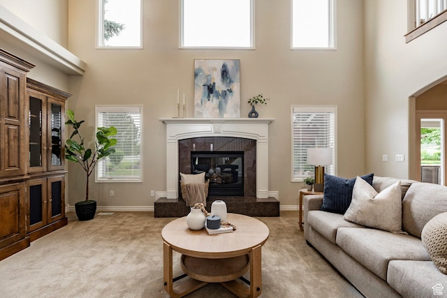 999 S Fairway Cir, Fruit Heights, UT 84037 - living area with a towering ceiling, light colored carpet, a high end fireplace, and arched walkways