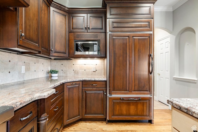 999 S Fairway Cir, Fruit Heights, UT 84037 - kitchen featuring built in appliances, crown molding, light wood-style flooring, backsplash, and light stone countertops