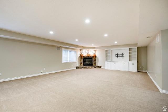 999 S Fairway Cir, Fruit Heights, UT 84037 - unfurnished living room with light carpet, a stone fireplace, recessed lighting, and built in features