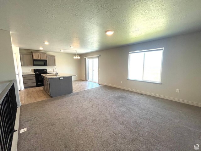 228 W 2370 N, Tooele, UT 84074 - unfurnished living room with a textured ceiling, a chandelier, light carpet, and recessed lighting
