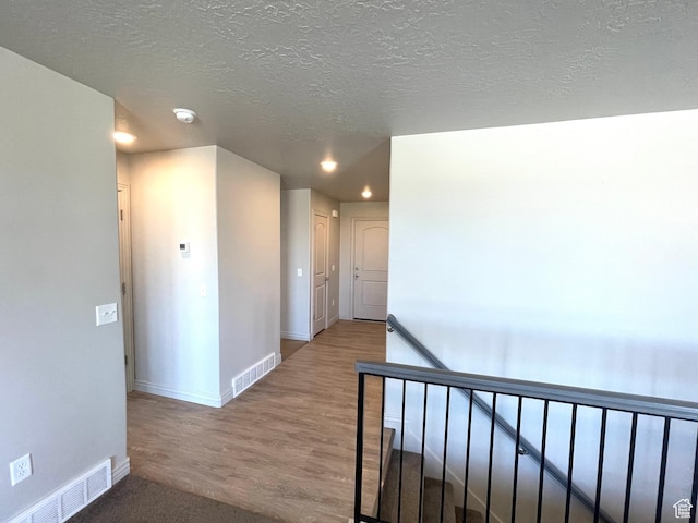 228 W 2370 N, Tooele, UT 84074 - hallway featuring an upstairs landing, recessed lighting, wood finished floors, and a textured ceiling