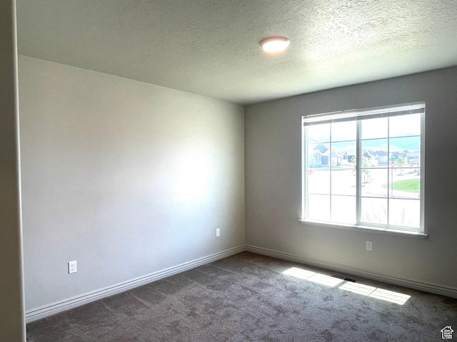 228 W 2370 N, Tooele, UT 84074 - carpeted empty room featuring a textured ceiling and baseboards