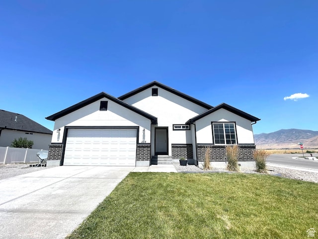 228 W 2370 N, Tooele, UT 84074 - ranch-style house featuring an attached garage, driveway, a mountain view, and stucco siding