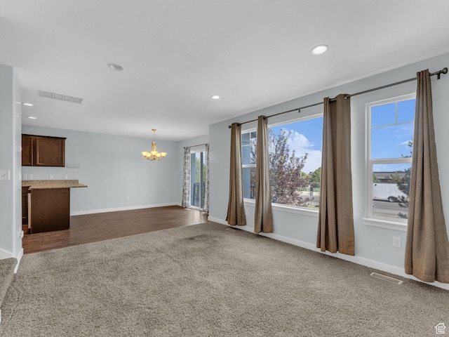 81 E E Side Hill Ln S, Draper, UT 84020 - unfurnished living room featuring dark colored carpet, a chandelier, and recessed lighting