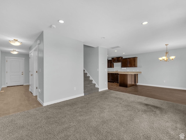 81 E E Side Hill Ln S, Draper, UT 84020 - unfurnished living room with carpet floors, a chandelier, recessed lighting, and stairs