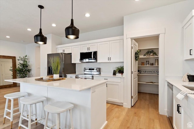 2081 W 1575th Ct S Unit 127, West Haven, UT 84401 - kitchen featuring stainless steel appliances, light wood-type flooring, a breakfast bar, white cabinets, and recessed lighting