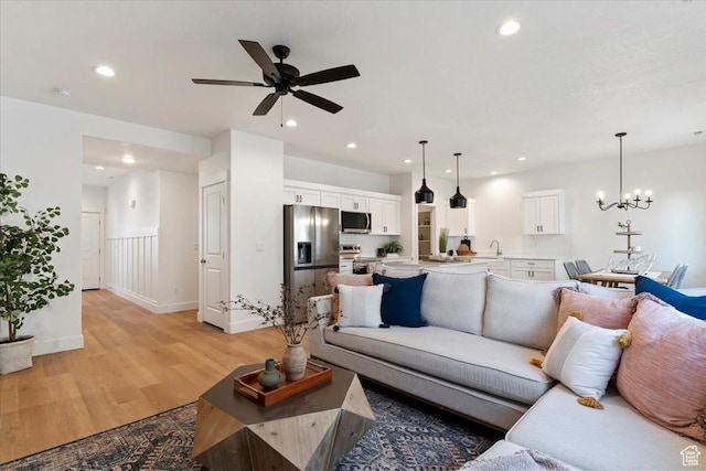 2081 W 1575th Ct S Unit 127, West Haven, UT 84401 - living area with light wood finished floors, ceiling fan, recessed lighting, and a chandelier