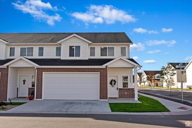 2081 W 1575th Ct S Unit 127, West Haven, UT 84401 - view of property featuring brick siding, concrete driveway, and an attached garage