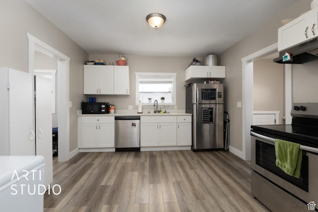 45 N 900 W, Provo, UT 84601 - kitchen with stainless steel appliances, under cabinet range hood, light wood-style flooring, and white cabinets