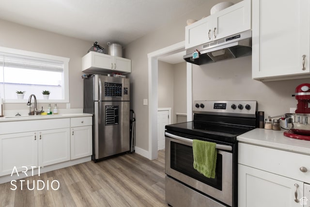 45 N 900 W, Provo, UT 84601 - kitchen featuring appliances with stainless steel finishes, under cabinet range hood, white cabinetry, light wood-style flooring, and light countertops